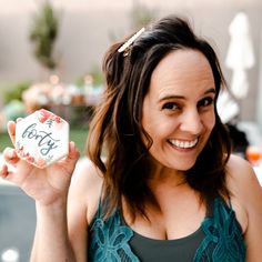 a woman holding up a sign that says forty