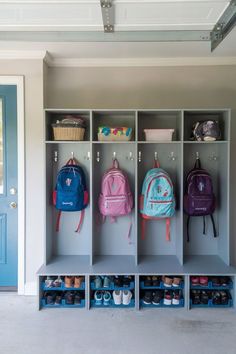 A modern garage mudroom with sleek, dark cabinetry, hooks, and a bench for stylish storage. Garage Mudroom Ideas, Gray Mudroom, Garage Lockers, Mudroom Ideas Diy, Laundry/mudroom Ideas, Kids Garage, Functional Mudroom, Garage Closet