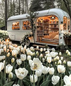 an rv is parked in the middle of some tulips and has its doors open