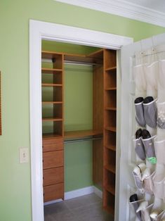 an open closet with shoes hanging on the wall