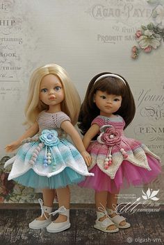 two dolls are standing next to each other