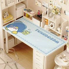 a desk with a cartoon character on it in a room filled with shelves and other items