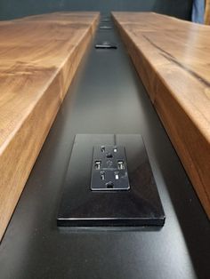 an electronic device sitting on top of a wooden table