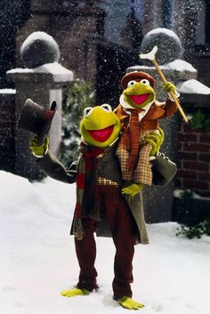 two muppets are standing in the snow