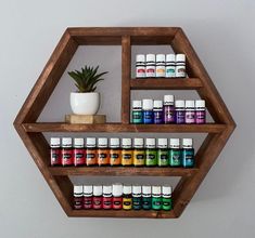 a wooden shelf filled with bottles of essential oils