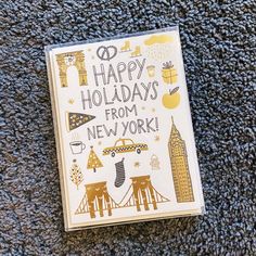 a new york holiday card with the words happy holidays from new york on it and an illustration of buildings