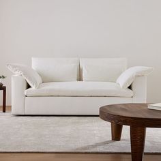 a living room with a white couch and coffee table