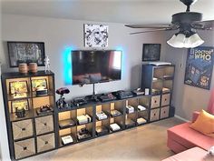 a living room filled with furniture and a flat screen tv on top of a wooden entertainment center