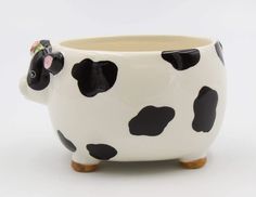 a black and white cow planter sitting on top of a table