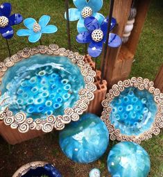 some blue and white vases sitting in the grass