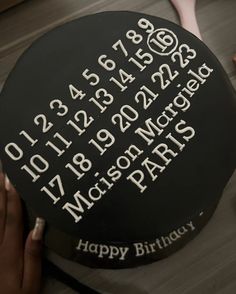 a black cake with white writing on it