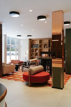 a living room filled with furniture and lots of windows