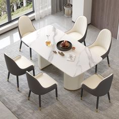 a dining table with chairs around it and a bowl of food on the table top