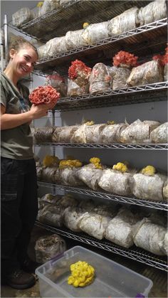 a woman standing in front of a shelf filled with food