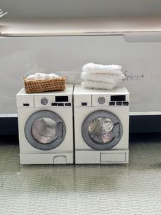 two washers are stacked on top of each other in front of a white wall