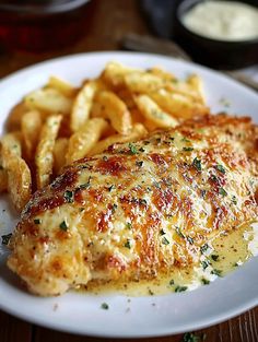 a white plate topped with chicken and french fries