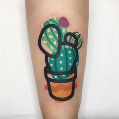 a small cactus tattoo on the leg