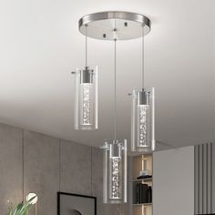 three lights hanging from the ceiling in a living room