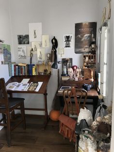 the room has many items on the table and chairs in it, including bookshelves