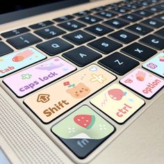 an open laptop computer with stickers on the keyboard