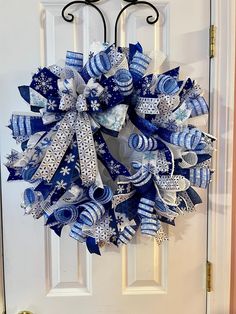 a blue and white wreath hanging on the front door