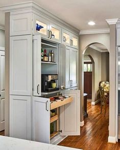 an open kitchen with white cabinets and wood flooring is featured in the article 4 coffee station ideas for your kitchen