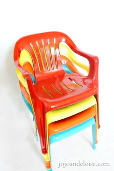 three plastic chairs stacked on top of each other