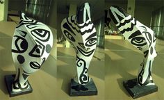 three different views of an art piece with black and white designs on it's body