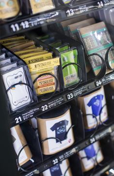 glasses and other items are on display for sale in a convenience store's eyewear section