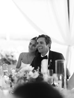 a man and woman sitting at a table together