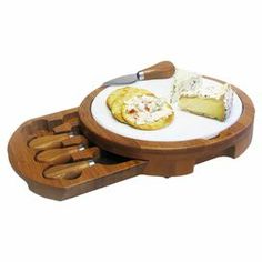 a wooden cutting board with cheese and bread on it