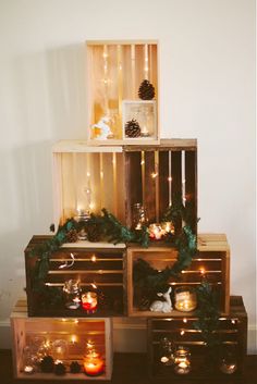 a stack of wooden crates filled with candles