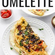 an omelette on a white plate with tomatoes