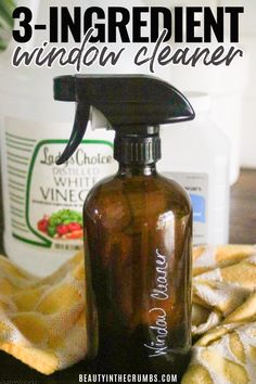 a bottle of vinegar cleaner sitting on top of a table next to a yellow towel