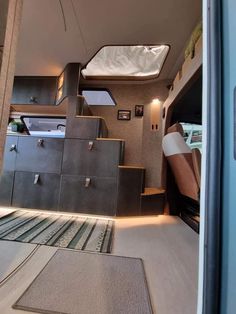 the interior of a tiny house with stairs leading up to the bed and storage area