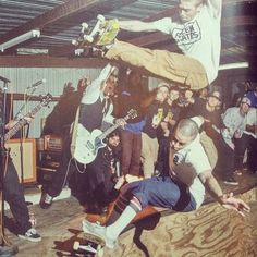 a group of young men standing next to each other on top of a skateboard ramp