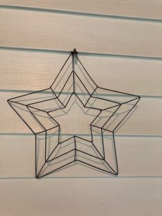 a metal star hanging on the side of a building