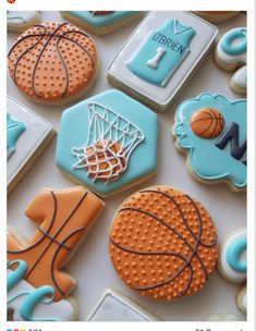 cookies decorated to look like basketballs, basketball hoop and other sports related items are arranged on a table