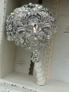 a bridal bouquet with pearls and crystals