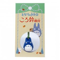 an ornament in the shape of a totoro with a green ribbon around it