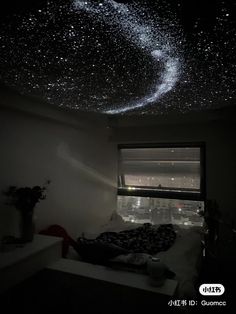 the ceiling is filled with stars and lights in the dark night sky above a bed