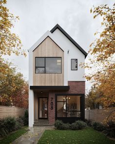 a modern house with wood and brick accents