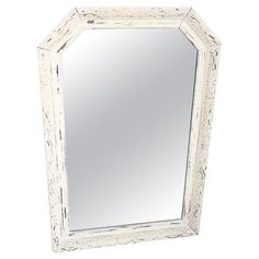 a large white mirror sitting on top of a table