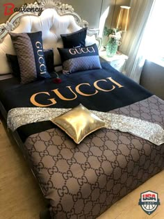 a gucci bed with gold and black pillows