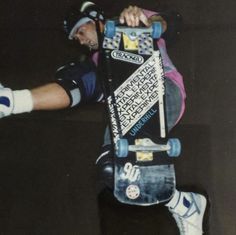 a skateboarder is doing a trick in the air with one hand on his board