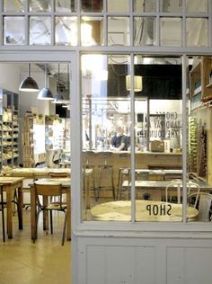 the shop is filled with wooden tables and chairs