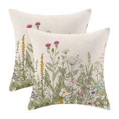 two pillows with flowers and plants on them