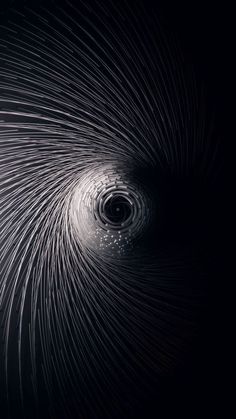 an abstract black and white photo with lots of lines in the shape of a spiral