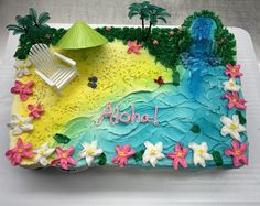 a birthday cake decorated with flowers and an umbrella on a white tablecloth covered tray