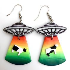 These Are A Ton Of Fun! I Handcrafted These Novelty Alien Spaceship/Ufo Earrings Out Of Polymer Clay And They Are Brand New And Fresh Out Of The Oven. Lightweight, Comfortable Dangle Earrings With Hooks. The Ships Are A Sparkly Metallic Silver And The Beams Are Gradient Rainbow Colors. Great For Pride Or Just If You Like A Lot Of Color. The Spaceship Is Beaming Up A Black And White Cow. There Are Some Minor Imperfections That Add Character To The Handmade Design And Make Them Truly One Of A Kind Ufo Earrings, Novelty Accessories, Home Made Jewelry, Cubic Zirconia Hoop Earrings, Diy Props, Alien Spaceship, Bottle Earrings, Betsey Johnson Earrings, Bling Earrings